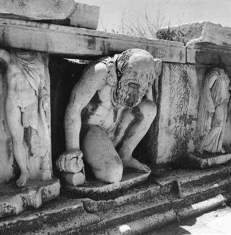 Dionysos, among other sculpture at the hyposcenium  (the low wall supporting the front of the stage in a Greek theater) of the Theater of Dionysos. Photo by N. Tombazi.