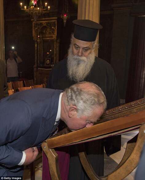 The Prince of Wales kisses an icon depicting the resurrection of Christ as he visits the Byzantine Church of Kapnikarea, Athens. © Getty Images